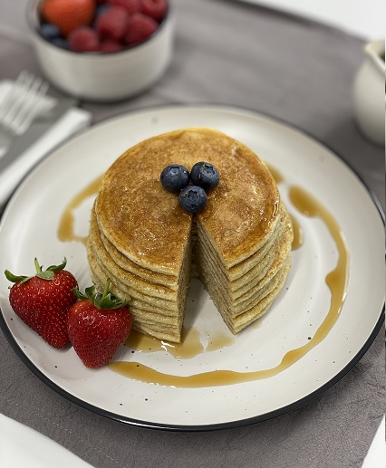 protein pancakes on white plate aerial shot with slice missing